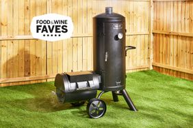 Dyna-Glo Signature Series Vertical Offset Charcoal Smoker displayed on grass