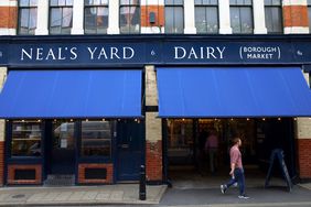 People at the entrance to Neal's Yard Dairy in Borough Market, London. The company started in 1979 and supplies cheeses made by farms across Britain and Ireland