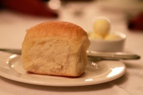 Close up of a parker roll and butter on a table at the Omni Parker House.