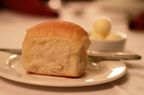 Close up of a parker roll and butter on a table at the Omni Parker House.