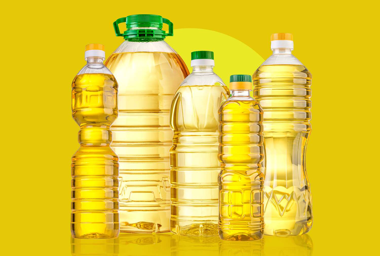 Various bottled cooking oils on a yellow background.