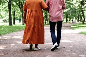 A couple walking on a park lane together. 