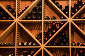 Wines stored on a geometric shelf. 