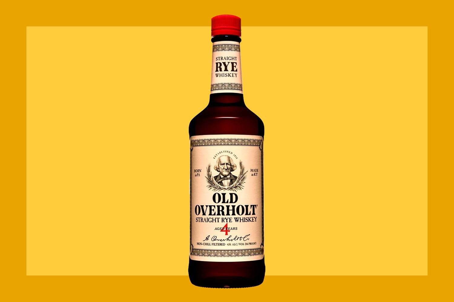 A bottle of Old Overholt Rye on a mustard colored background. 