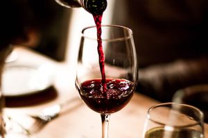 Red wine being poured into a glass.