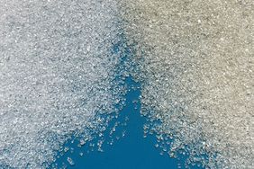 Granulated and cane sugar on a blue cutting board, 