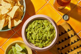 Bowl of chunky guacamole with a side of tortilla chips