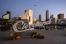 Cleveland sign at dusk with pumpkins.