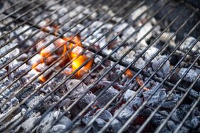 Hot coals burning on a barbecue grill.