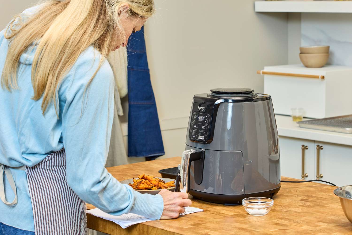 A person observes the Ninja 4-Quart Air Fryer during testing