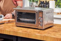 The Breville the Smart Oven Air Fryer on a wooden table