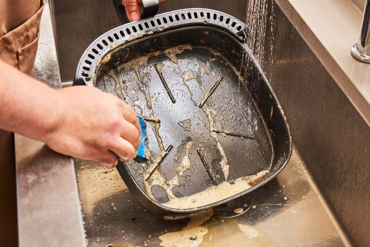 A person washing the Typhur Dome in a sink