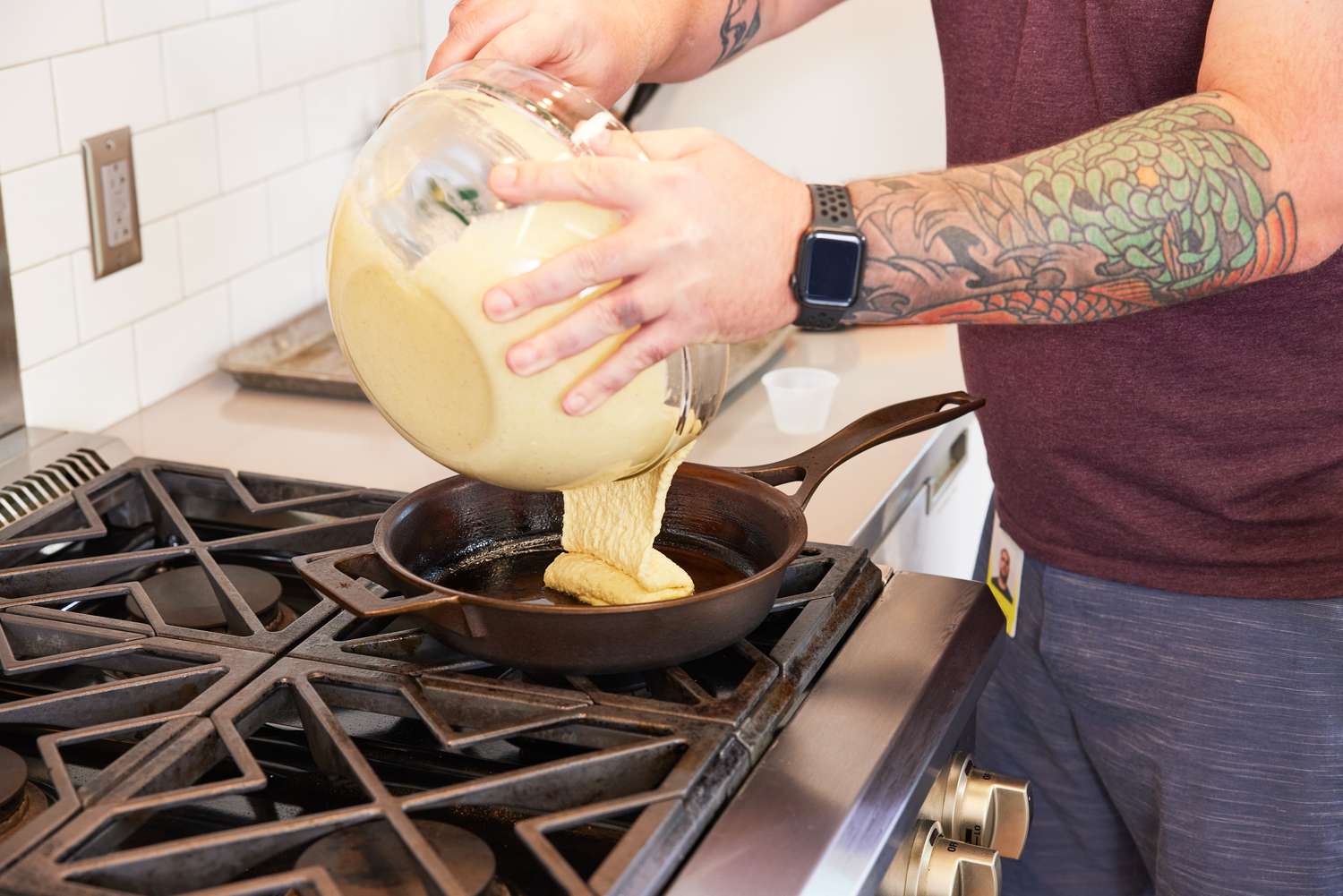 Person pouring batter into a Stargazer 10.5-Inch Cast Iron Skillet