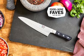 Mac Knife 8-Inch Hollow Edge Chef's Knife On Cutting Board WIth Vegetables And Molcajete