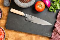 The Shun Classic Chef's 8-Inch Knife with vegetables on a cutting board