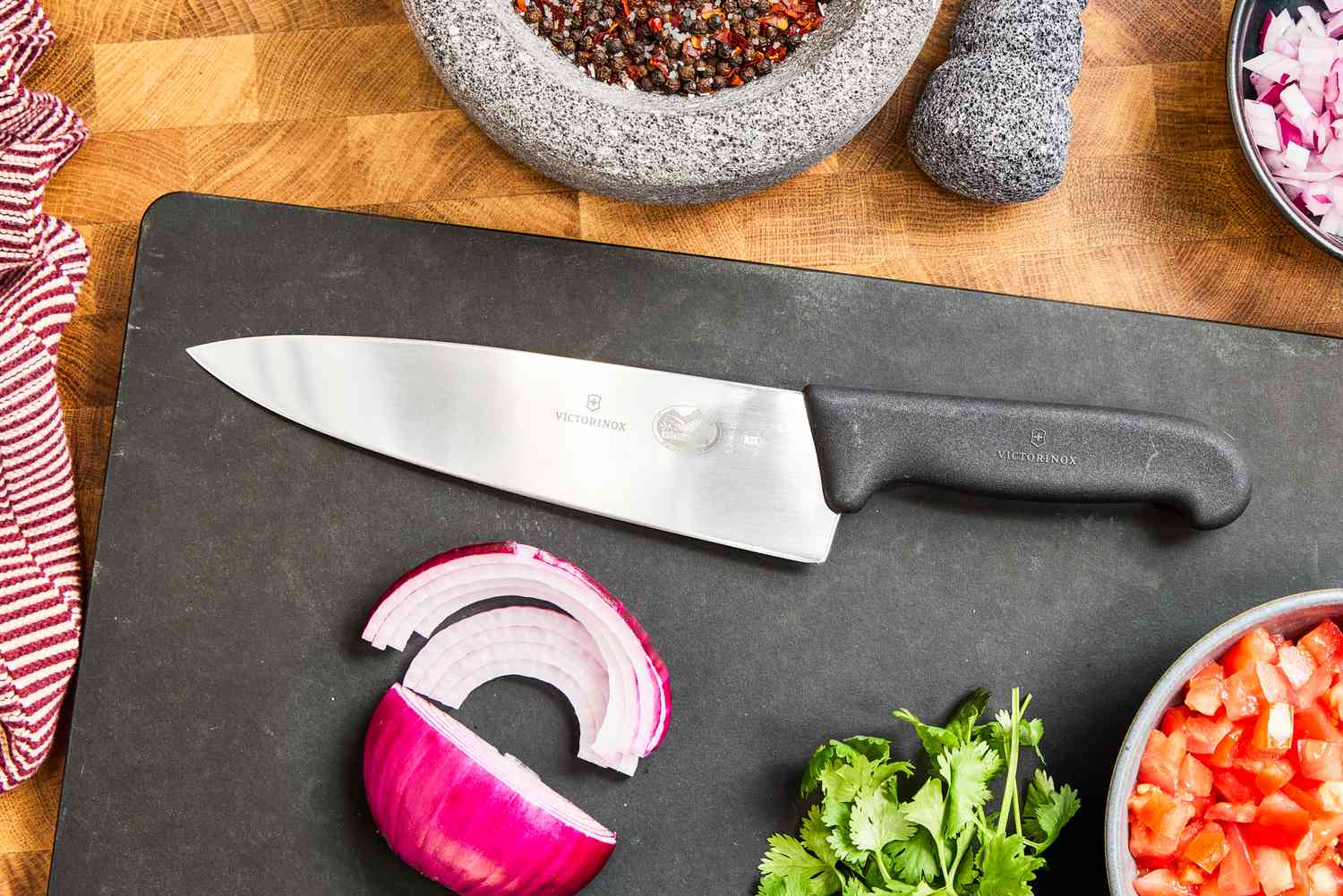 Victorinox Fibrox Pro 8-Inch Chef’s Knife on a cutting board with sliced onion