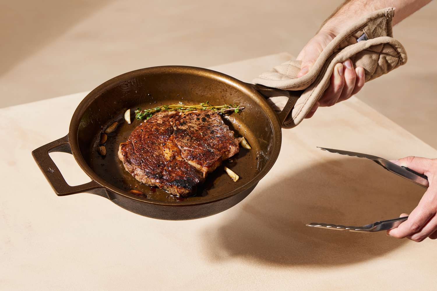 Person using the Stargazer cast iron skillet