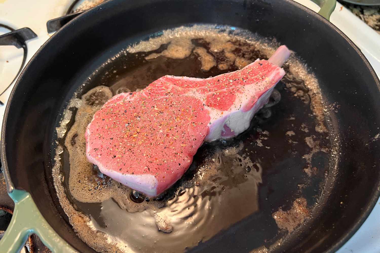 a steak cooking in an Our Place always pan