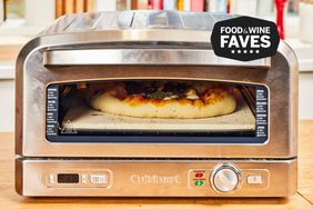 Pizza being baked in Cuisinart pizza oven with Food and Wine badge in top right