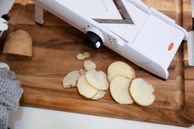 The OXO V-Blade Mandoline Slicer slices a potato