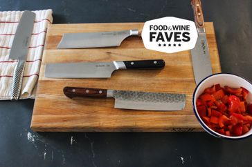 A group of nakiri knives on a cutting board