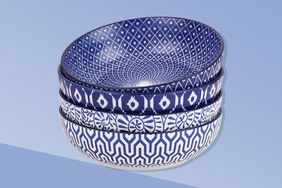 The blue and white Selamica Ceramic Large Pasta Bowls on a blue background