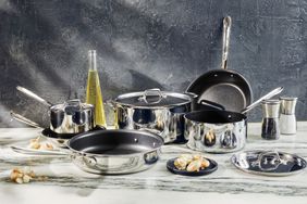 All-Clad D3 Stainless Steel Tri-Ply Bonded 10-Piece Nonstick Cookware Set displayed on marble surface