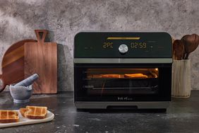 Toast inside Instant Pot Omni Plus 18L Air Fryer Toaster Oven on countertop next to tray of toast and utensils