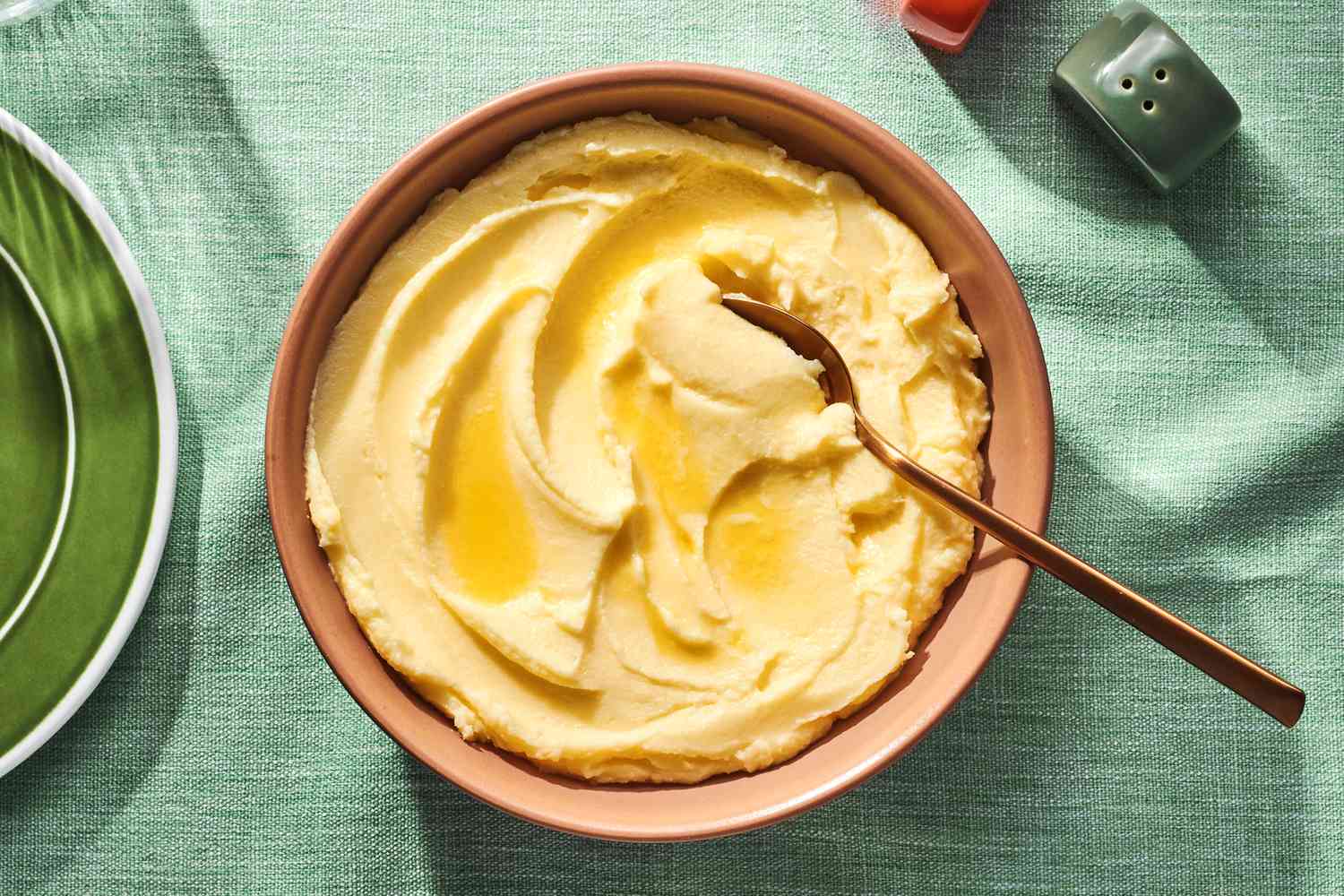 A large bowl of Robuchon-style mashed potatoes topped with melted butter