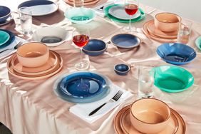 Several dinnerware sets displayed on a long table