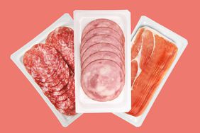 Three packages of ready-to-eat meat on a salmon colored background. 