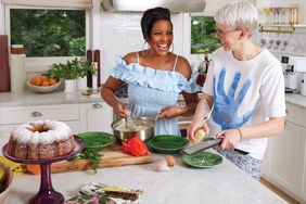 Tamron Hall in the kitchen cooking and smiling