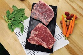 Cuisinart CDT-010 BBQ Defrosting Tray on a kitchen table with veggies near by