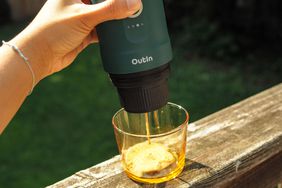 Outin Nano Portable Electric Espresso Machine Squeezed into a cup