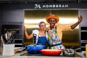 Marcus Samuelsson and Fariyal Abdullahi pose in a Monogram demo kitchen at the 2024 Food & Wine Classic in Aspen