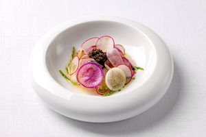 A dish with shaved radishes and caviar from Raffles at OWO