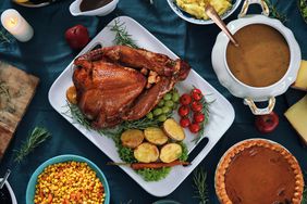 Stuffed Turkey for Thanksgiving Holidays with Pumpkin pie, gravy, mashed potatoes and corn.