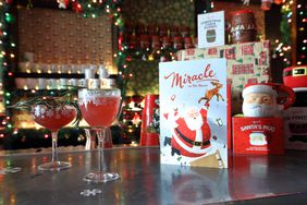 Drinks, a card and mugs on the bar.