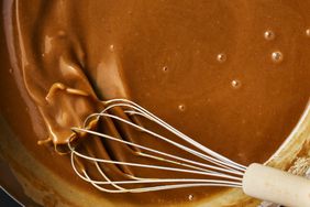 Gravy being whisked in a pan.