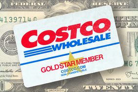 A Costco Wholesale membership card over a twenty dollar bill.