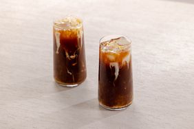 Iced Cafe de Olla in two highball glasses with cream floating on top