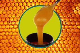 A spoonful of Manuka honey in front of a honeycomb. 