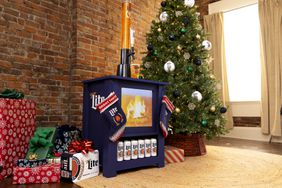 Miller Lite's New YuleLager, the Fireplace Keg Combo, next to a Christmas tree and gifts.