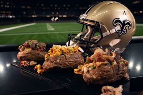 Loaded baked potatoes at Caesars Superdome in New Orleans with a football helmet.