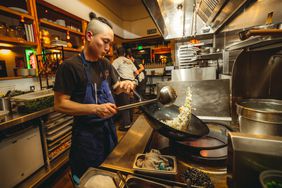 Franky Ho cooking in the kitchen of Four Kings in San Francisco.