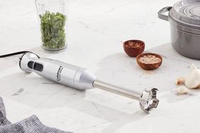 The Chef-Loved Cuisinart Smart Stick Immersion Blender laying on a kitchen counter next to ingredients