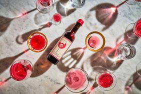 Pizza Hut's tomato wine and wine glasses on a marble surface. 