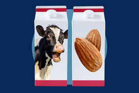 Two milk cartons on a blue background. One with a cow and one with almonds on the front. 