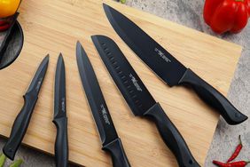 Set of five knives on cutting board