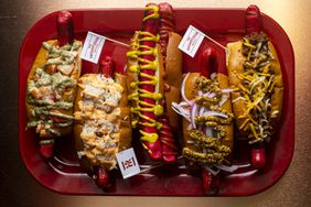 Top down view of a Maine red hot dogs with a variety of toppings at The Highroller Lobster Co in Portland, Maine.